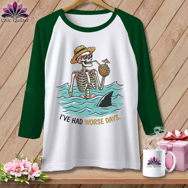 White baseball tee with skeleton in water, shark fin, and "I've had worse days" text.