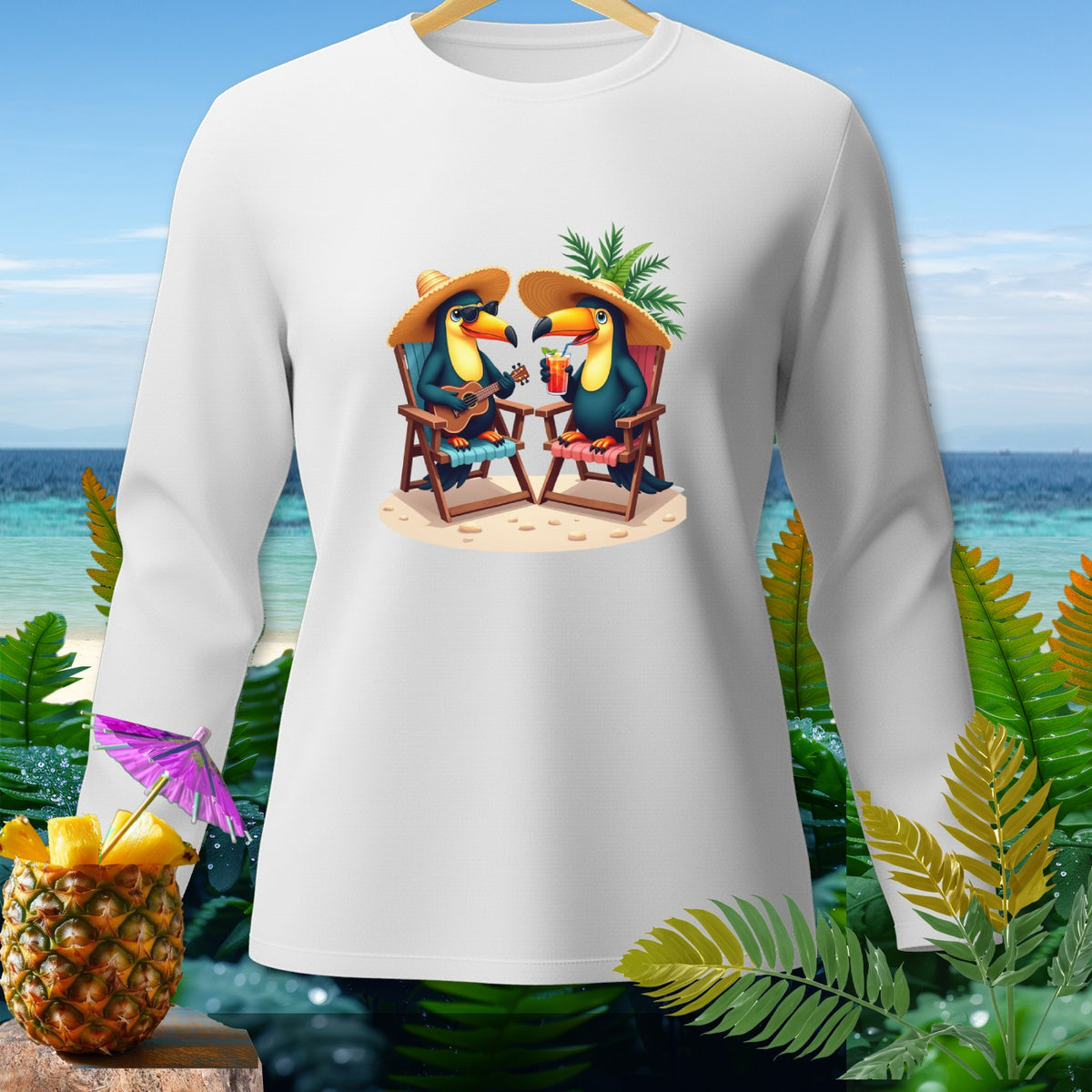 White long-sleeve shirt with cartoon toucans on a beach wearing straw hats.