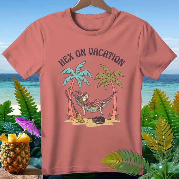 T-shirt with witch in hammock, broom, cat, and "Hex on Vacation" text.
