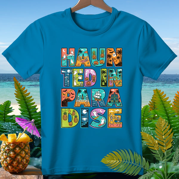 Teal t-shirt with "Haunted in Paradise" text featuring Halloween and beach-themed graphics.