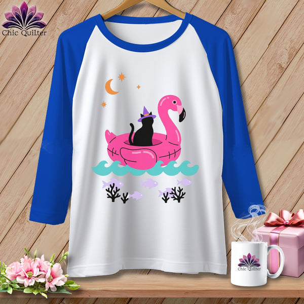 Raglan shirt with black cat on flamingo float and crescent moon graphic.