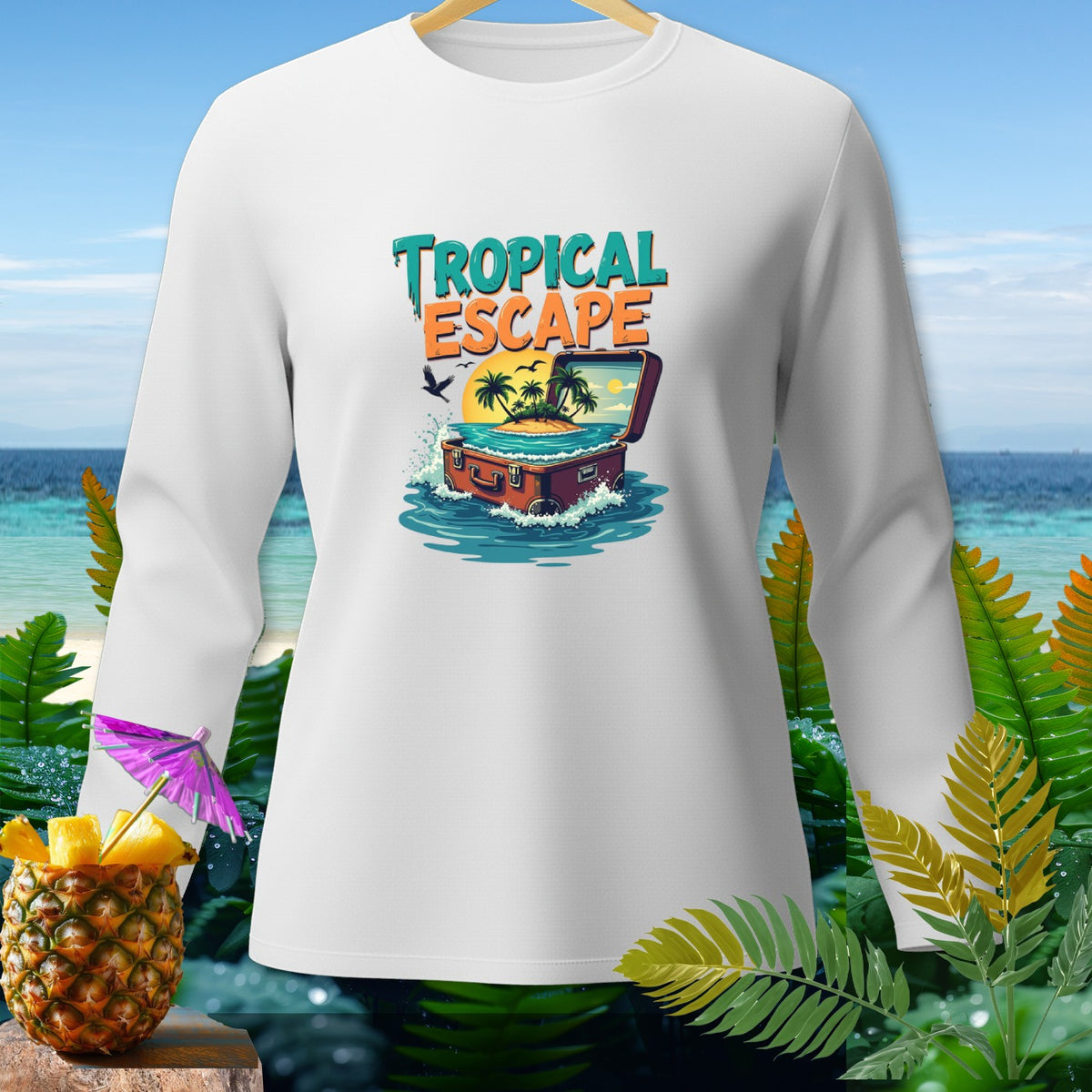 White long-sleeve shirt with "Tropical Escape" graphic of a suitcase with an island inside.
