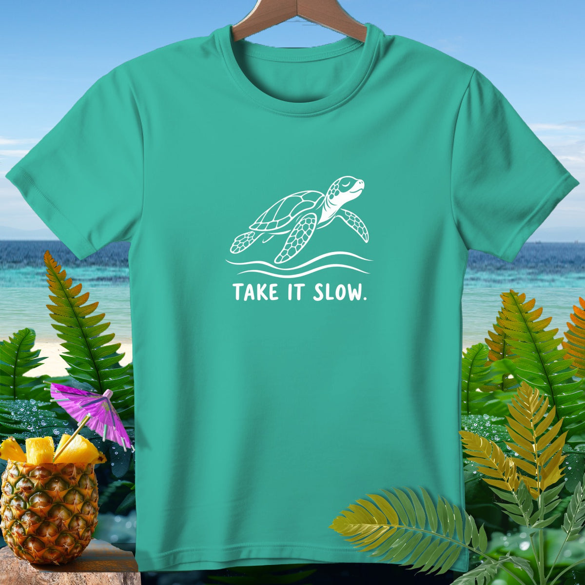Teal t-shirt with white sea turtle and "TAKE IT SLOW." text.