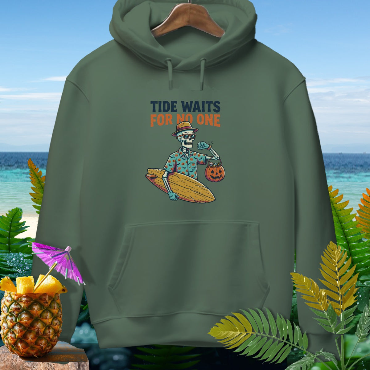 Green hoodie with graphic of skeleton holding surfboard and pumpkin, text "Tide Waits For No One".