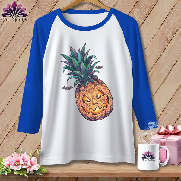 White raglan t-shirt with a jack-o'-lantern pineapple and bats graphic.