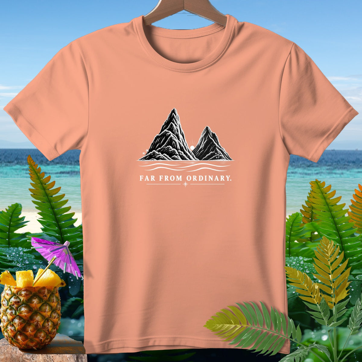 Peach t-shirt with mountains graphic and "FAR FROM ORDINARY." text.