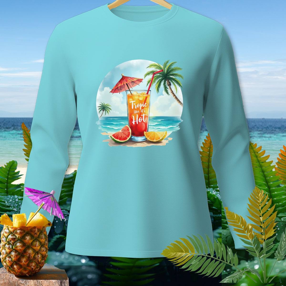 Teal long-sleeve shirt with a tropical drink, beach scene, and text "Tropic like it's Hot".