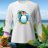 White long-sleeve shirt with cartoon penguin in sunglasses on beach.