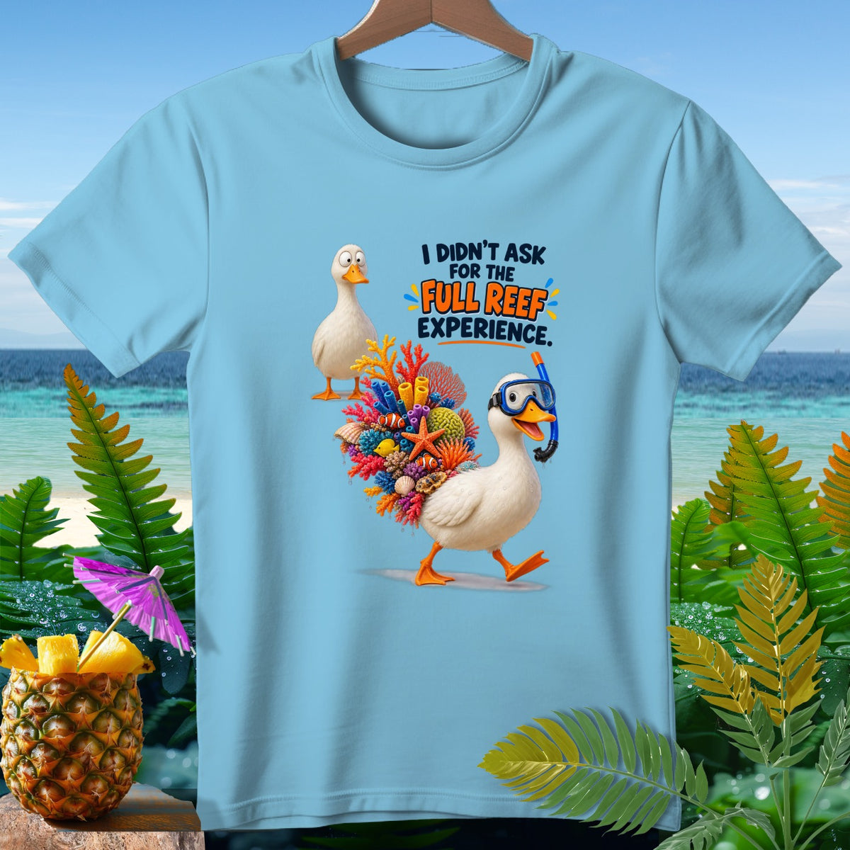 Light blue t-shirt with cartoon ducks, coral, and text "I didn't ask for the full reef experience."
