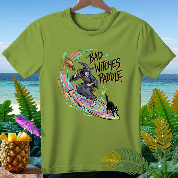 Green t-shirt with "Bad Witches Paddle" text and a witch surfing with a black cat.