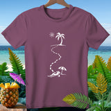 Maroon t-shirt with white graphic of footprints leading to a person relaxing on a beach under an umbrella.