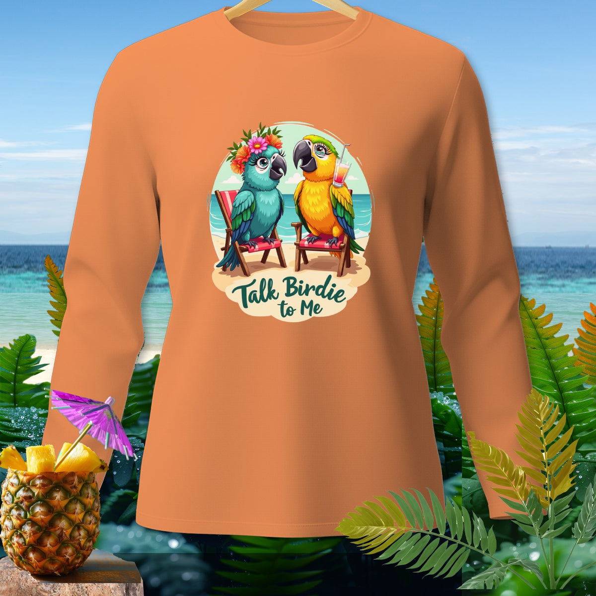 Orange long-sleeve shirt with cartoon parrots and "Talk Birdie to Me" text.