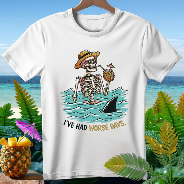 Skeleton wearing sunglasses and hat, drinking from pineapple, with shark fin. "I'VE HAD WORSE DAYS."