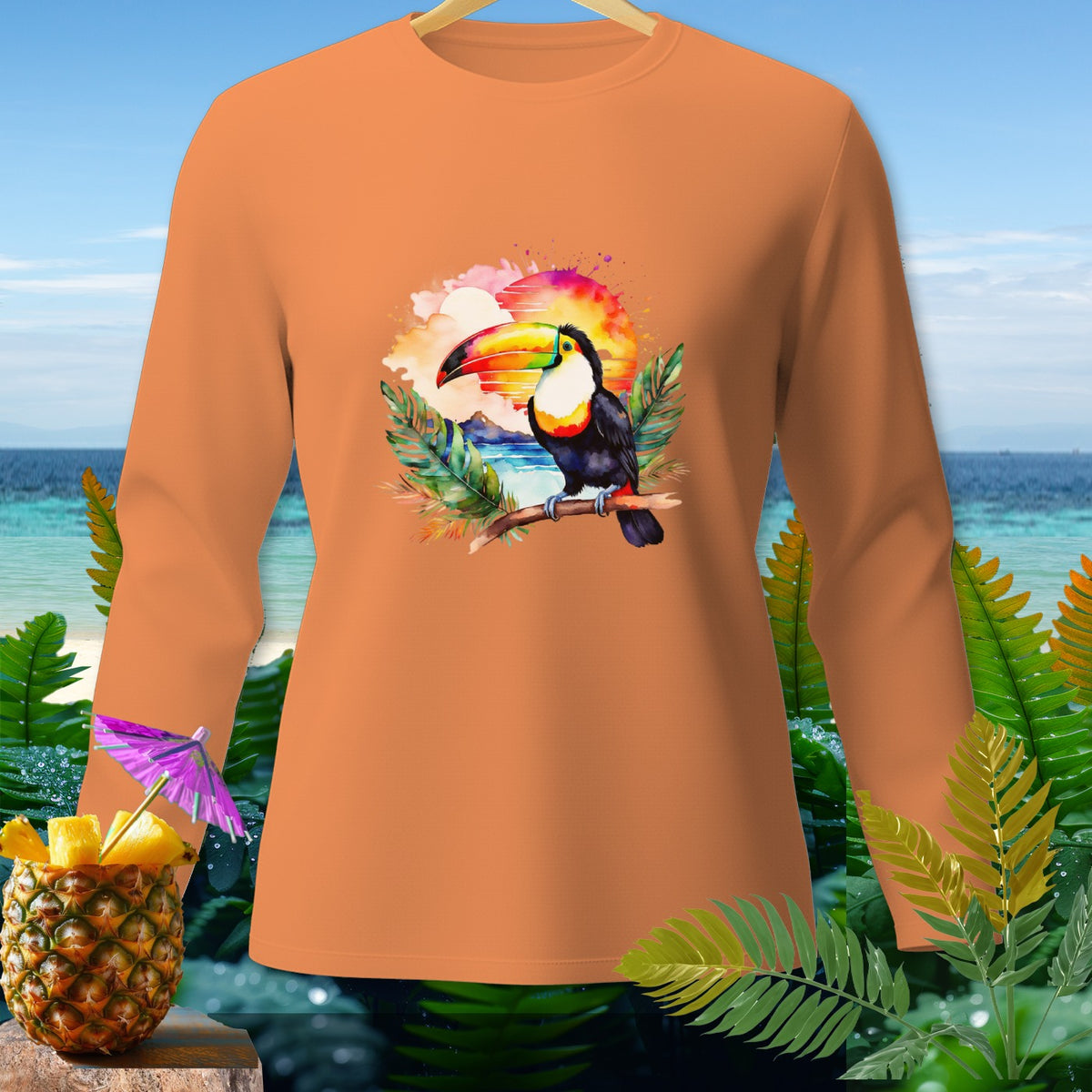 Orange long-sleeve shirt with toucan and sunset design.