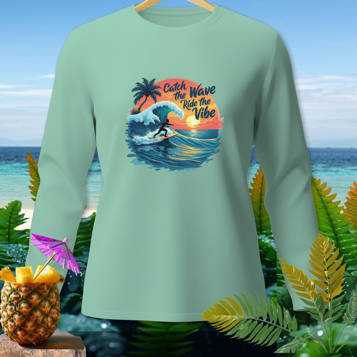 Mint long-sleeve shirt with "Catch the Wave Ride the Vibe" surfing graphic.