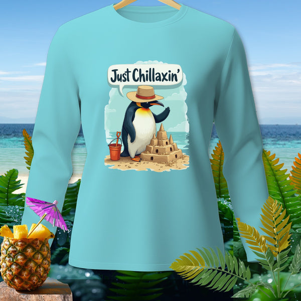 Light blue long-sleeve shirt with a penguin building a sandcastle, saying "Just Chillaxin'".