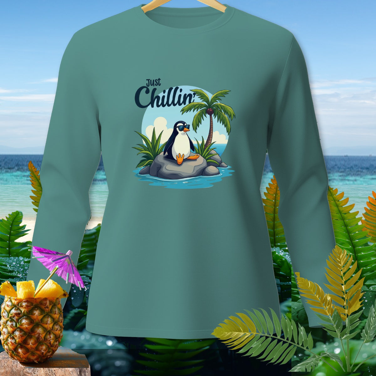 Teal long-sleeve shirt with cartoon penguin and "Just Chillin" text.