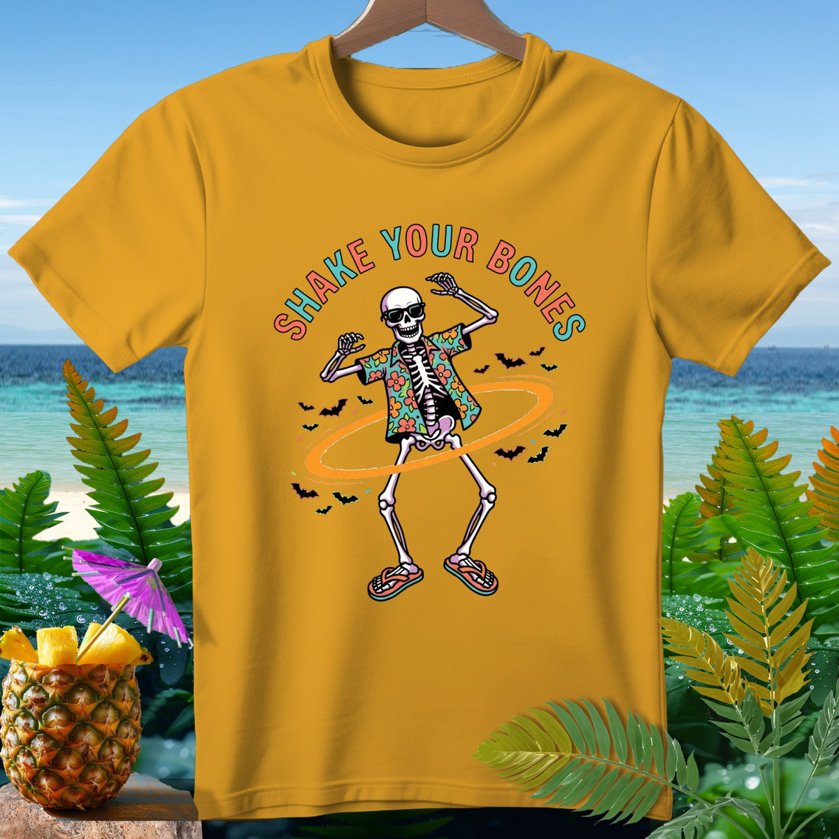 Yellow t-shirt with a skeleton dancing and text that reads "Shake Your Bones".