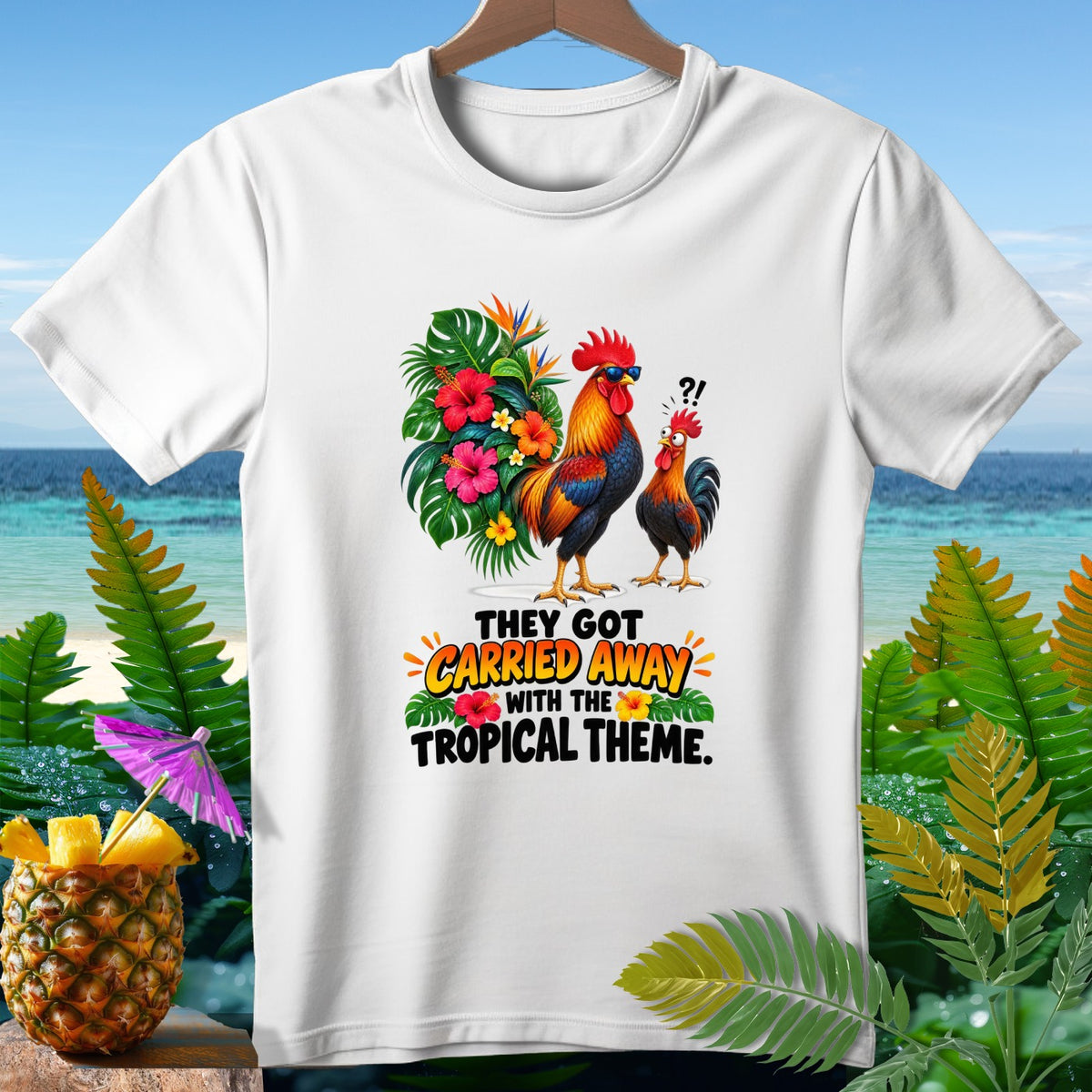 White t-shirt with roosters and tropical flowers, reading "They Got Carried Away With The Tropical Theme."