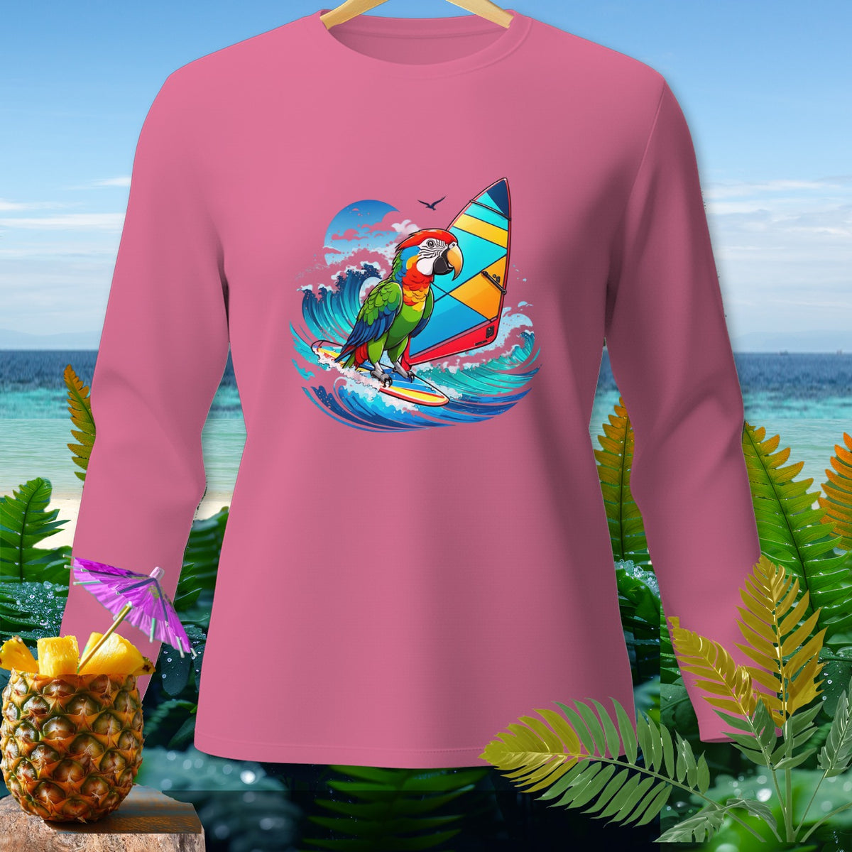 Pink long-sleeve shirt with a graphic of a parrot windsurfing on a wave.