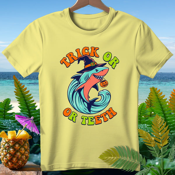 Yellow t-shirt with a shark wearing a witch hat and holding a pumpkin, with text "Trick or Teeth".