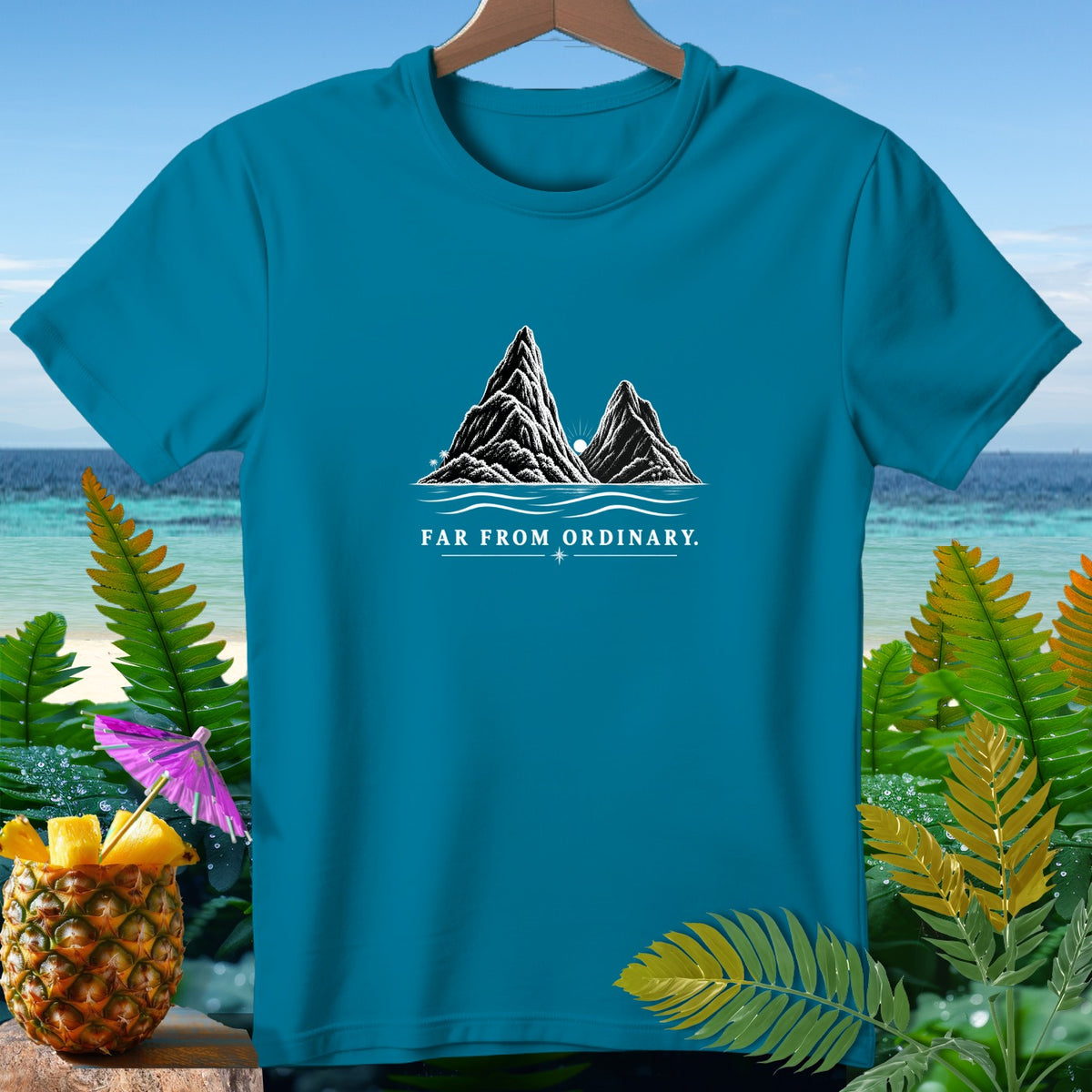 Teal t-shirt with mountain graphic and text "FAR FROM ORDINARY."