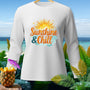 White long-sleeve shirt with "Sunshine & Chill" text and tropical beach background.