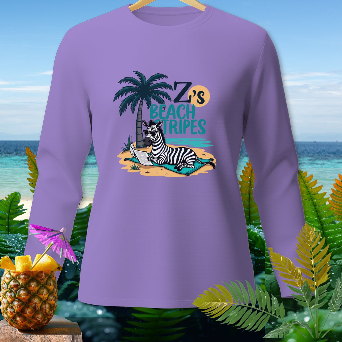 Purple long-sleeve shirt with a zebra on a beach reading "Z's Beach Tripes".