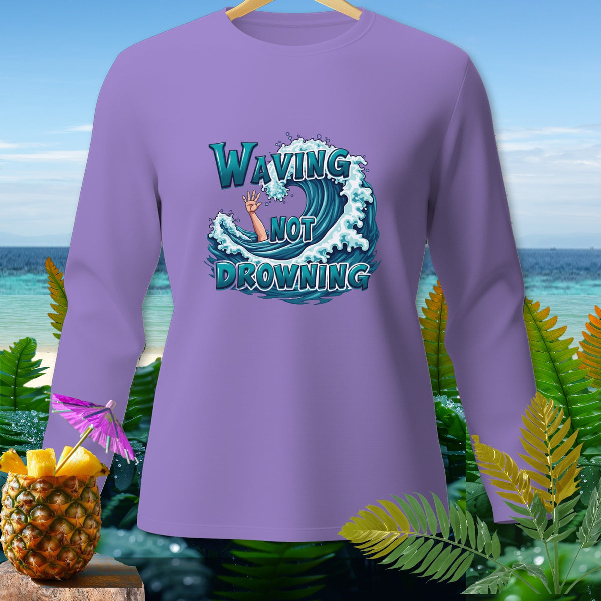 Purple long-sleeve shirt with "Waving Not Drowning" text graphic featuring a wave and an arm.