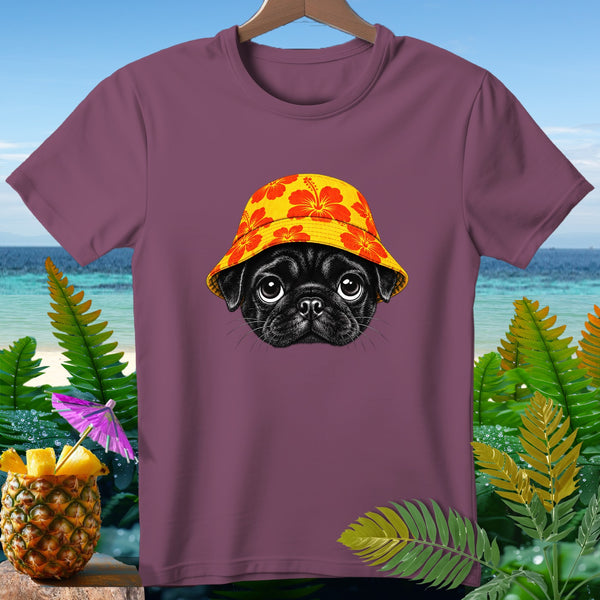 Black pug wearing a floral bucket hat on a plum t-shirt with beach background.