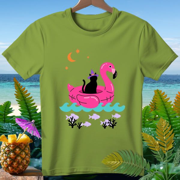 Black cat in witch hat on pink flamingo float with ocean and beach background.