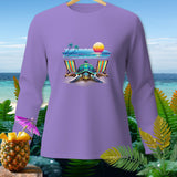 Purple long-sleeve shirt with a beach scene featuring a turtle, lounge chairs, and a sunset.