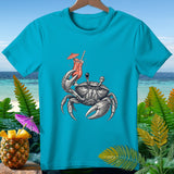 Crab holding a cocktail and a pineapple with a tiny umbrella on a turquoise t-shirt.