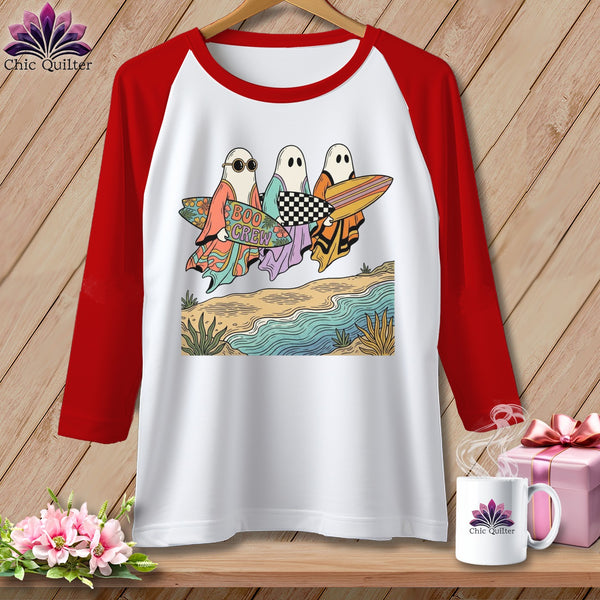 White raglan t-shirt with "Boo Crew" ghost graphic holding surfboards on a beach.