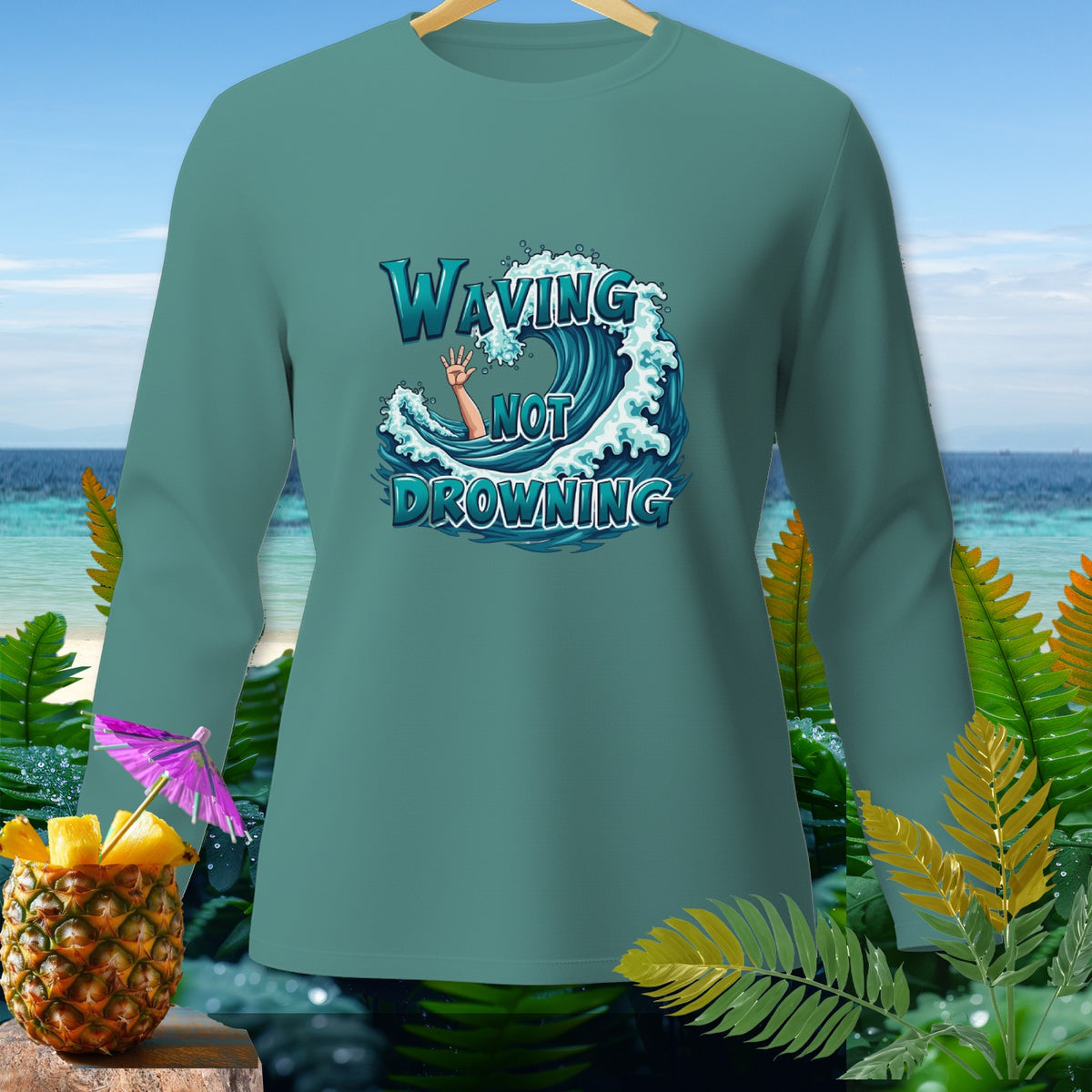 Teal long-sleeve shirt with "Waving Not Drowning" text and wave graphic.