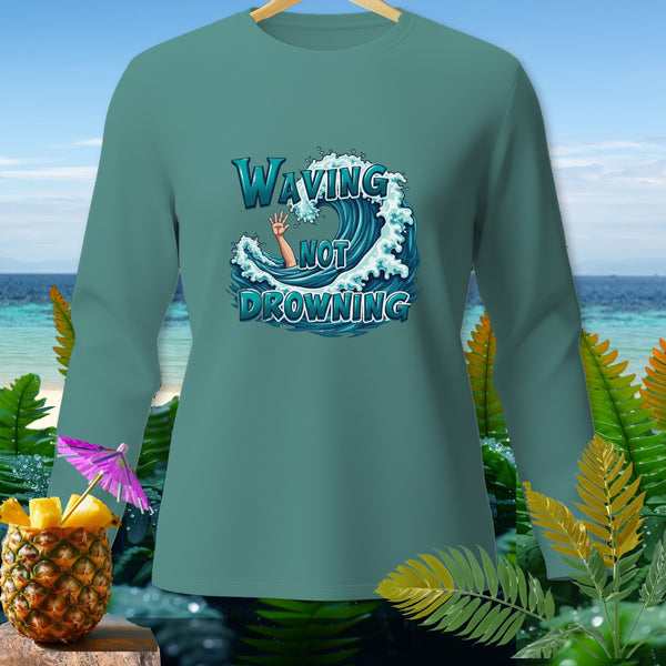Teal long-sleeve shirt with "Waving Not Drowning" text and wave graphic.