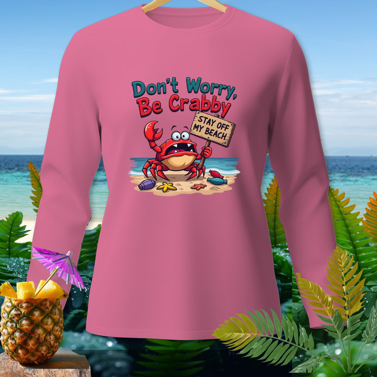 Pink long sleeve shirt with crab graphic saying "Don't Worry, Be Crabby".