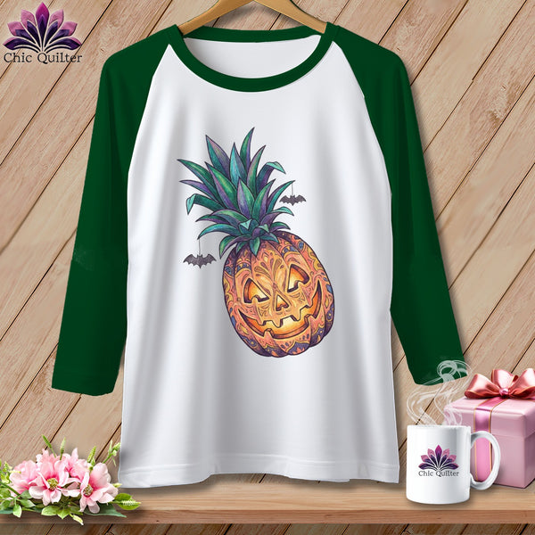 White baseball tee with a Halloween pineapple graphic and bats.