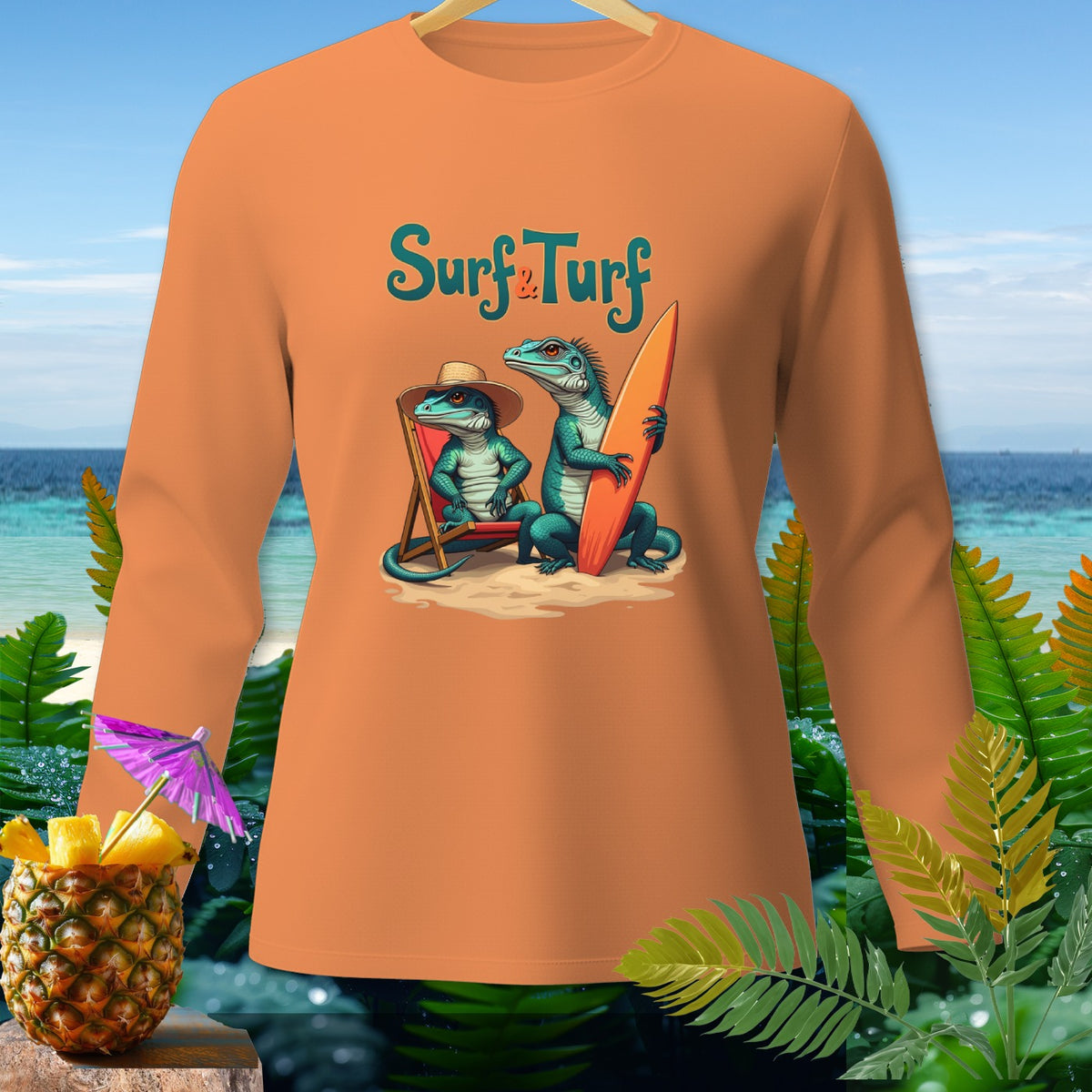 Orange long sleeve shirt with "Surf & Turf" text and two iguanas on a beach.