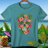 Teal t-shirt with a floral skull design and tropical foliage.
