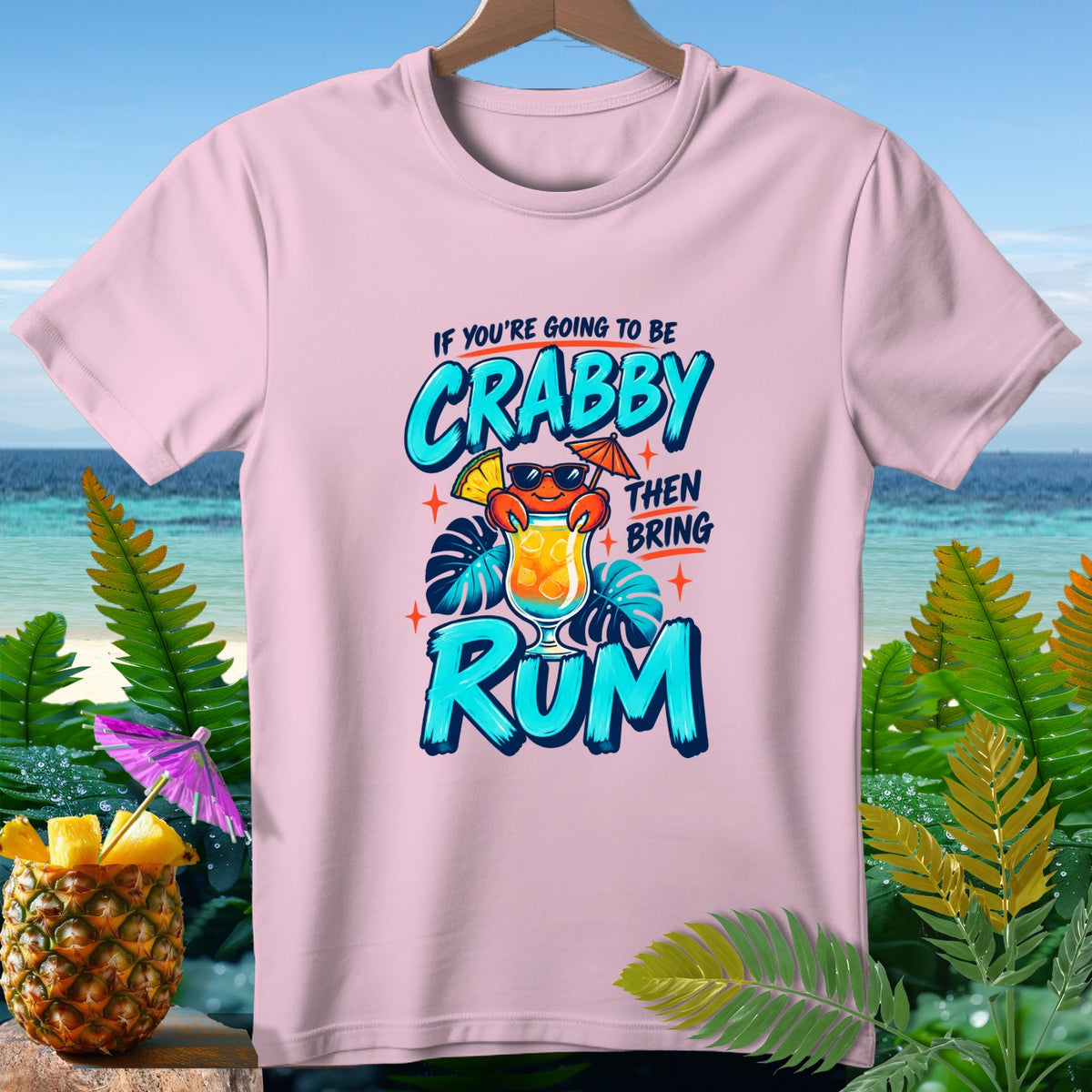 Pink t-shirt with cartoon crab holding cocktail and text "If you're going to be crabby then bring rum".