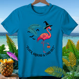 Turquoise t-shirt with a flamingo wearing a witch hat and holding a pumpkin, with text 