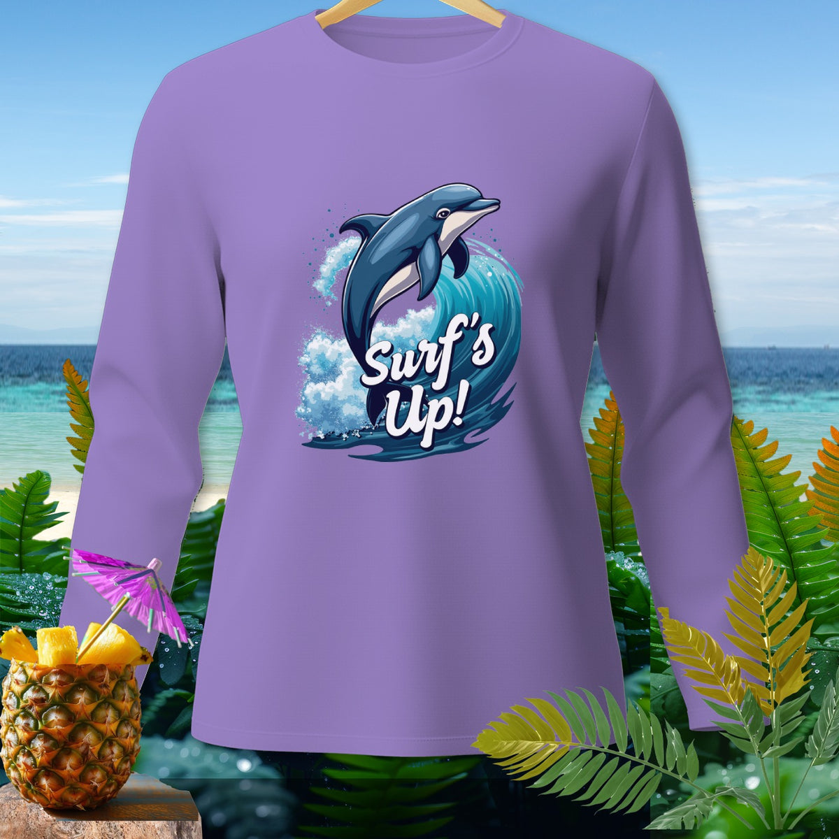 Lavender long sleeve shirt with dolphin and wave graphic that says "Surf's Up!".