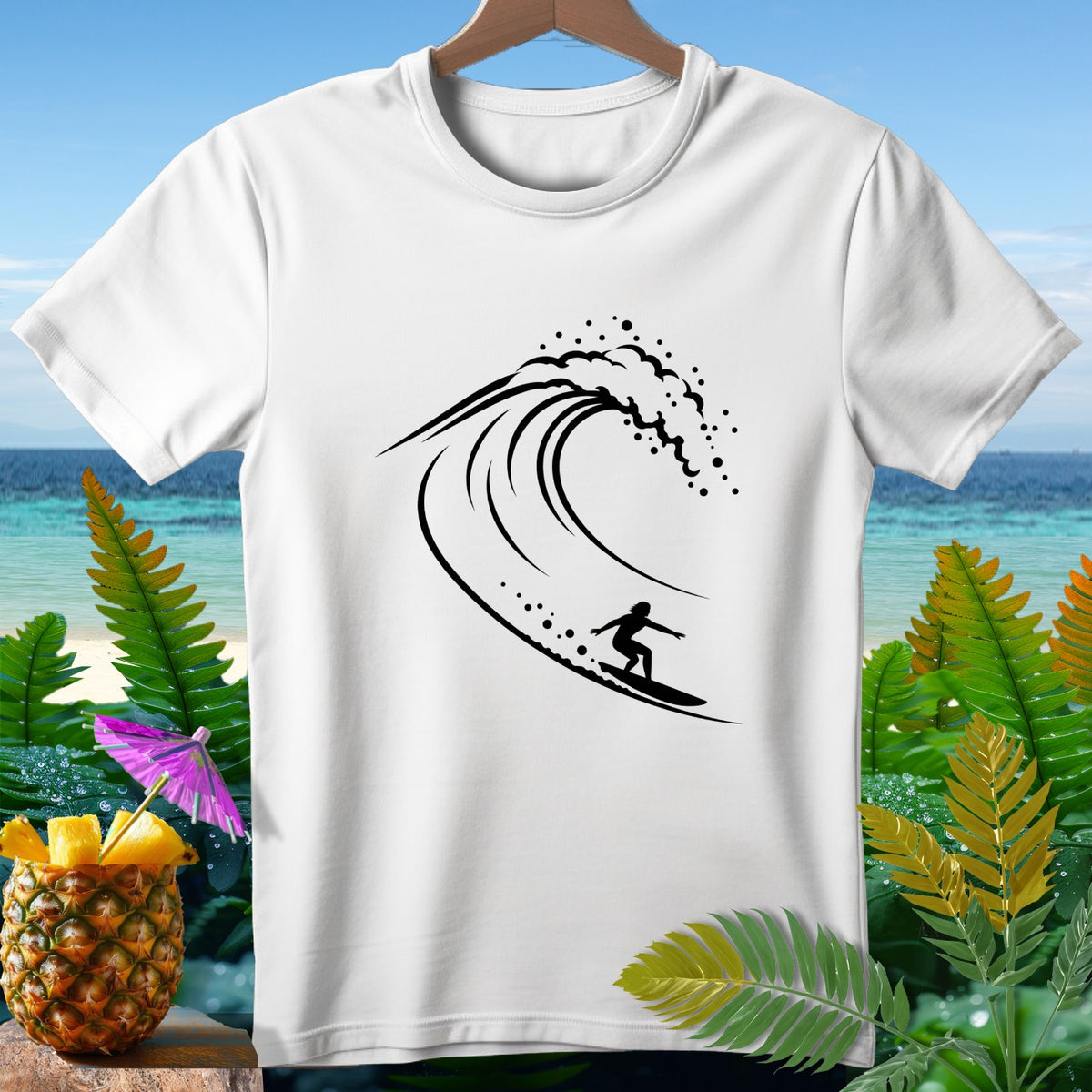 White t-shirt with black surfer on wave graphic, tropical background.