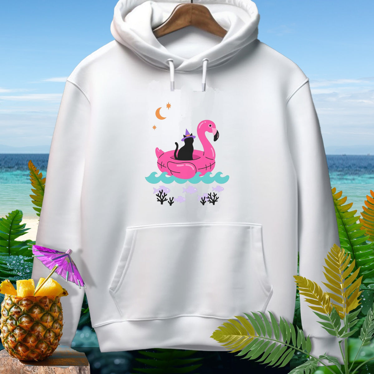 White hoodie with graphic of black cat on pink flamingo float, moon, and fish.