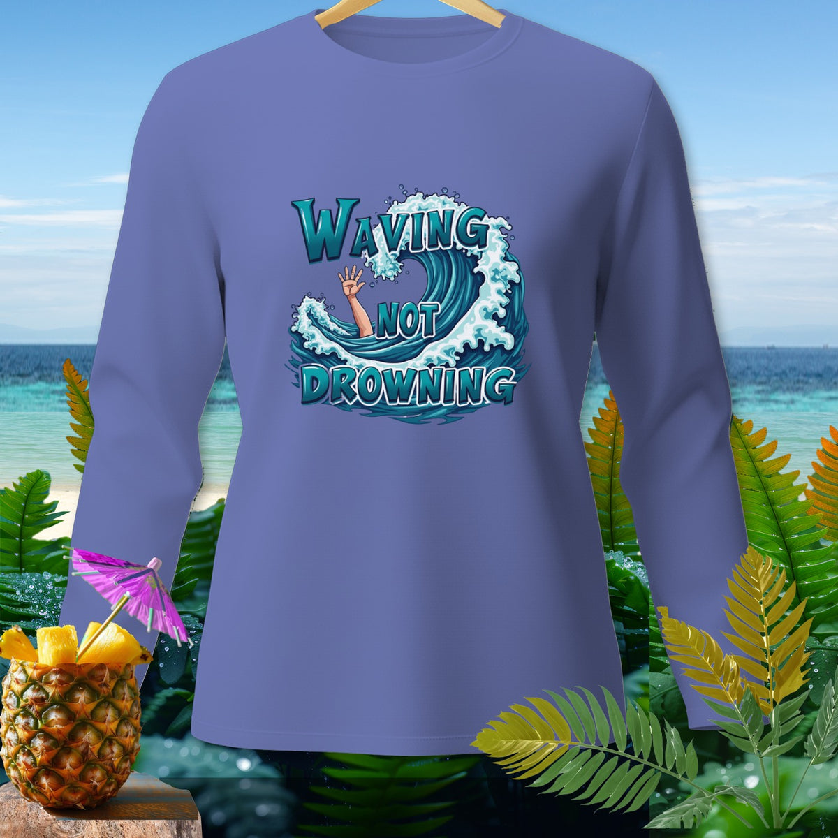 Long sleeve shirt with text "WAVING NOT DROWNING" on a wave graphic.