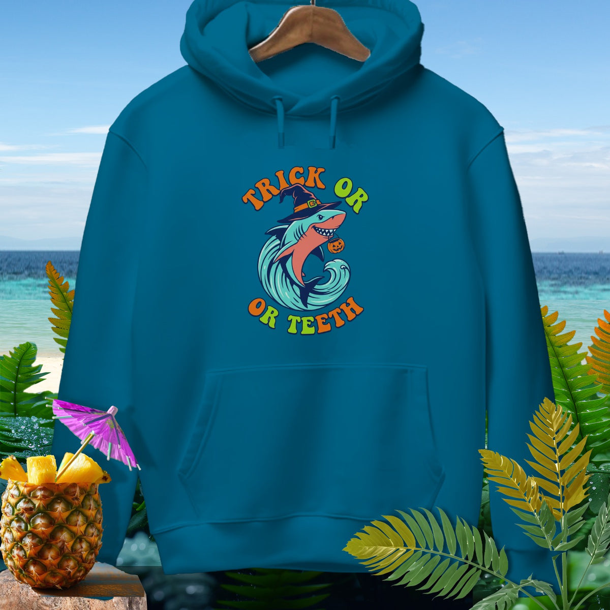 Teal hoodie with Halloween shark graphic and "Trick or Teeth" text.