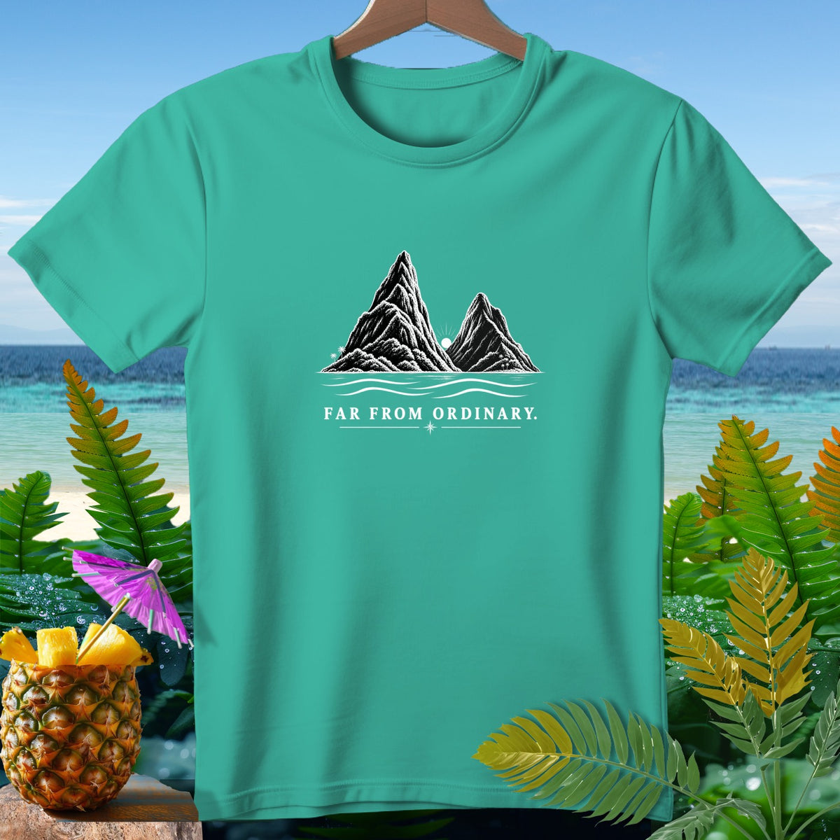 Teal t-shirt with mountains, ocean, and "FAR FROM ORDINARY" text.