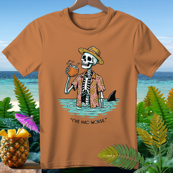 Orange t-shirt with skeleton in Hawaiian shirt drinking coconut, shark fin visible.