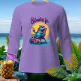 Purple long-sleeve shirt with a cartoon chameleon relaxing on a beach chair with text 